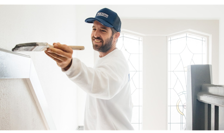 worker painting building interior