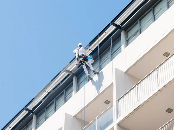 high rise painter abseiling on strata building