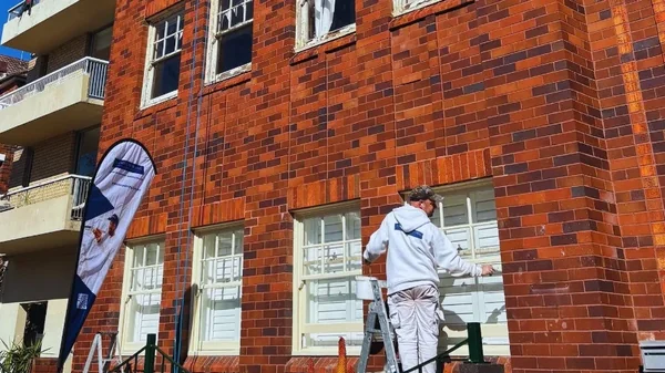 professional strata painter painting window sill as building maintenance