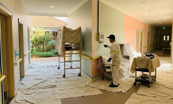 painter painting the interior walls of an aged care facility